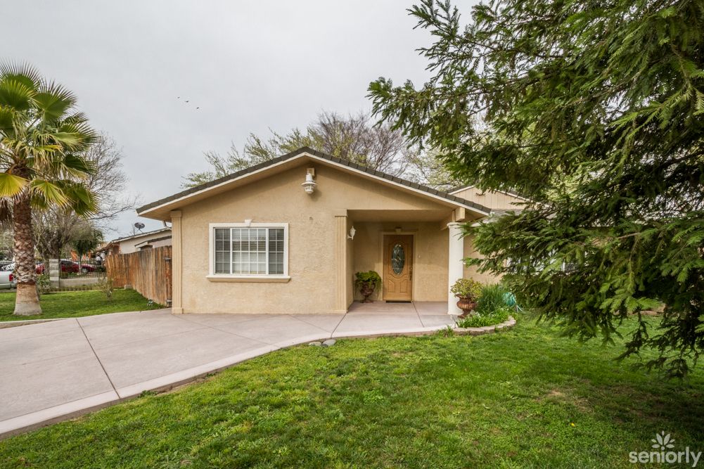 A suburban house with a well-maintained front yard and driveway.