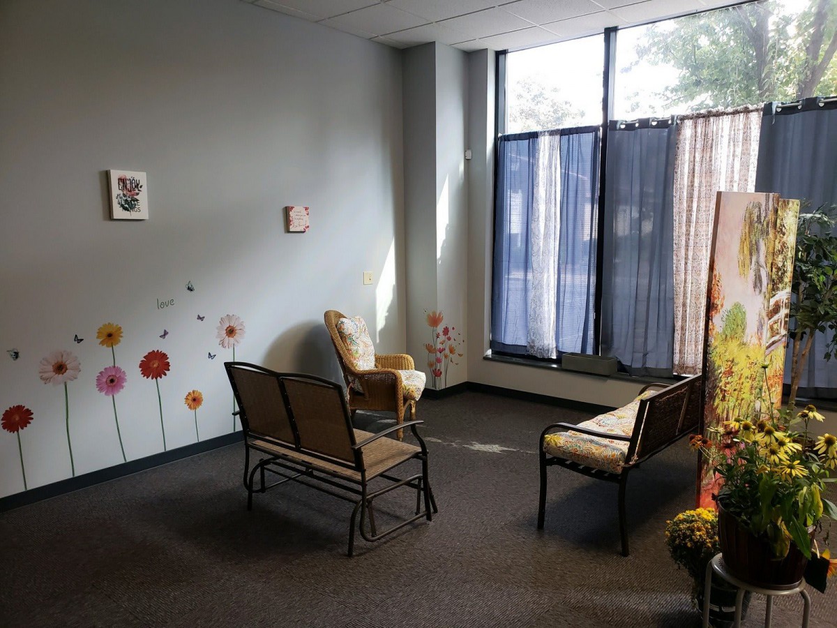 A cozy waiting room with chairs and decorative elements.