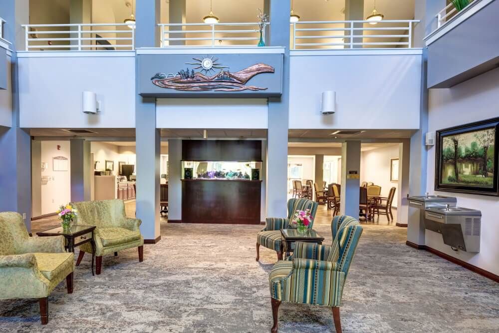 A spacious hotel lobby with comfortable seating and a reception desk.
