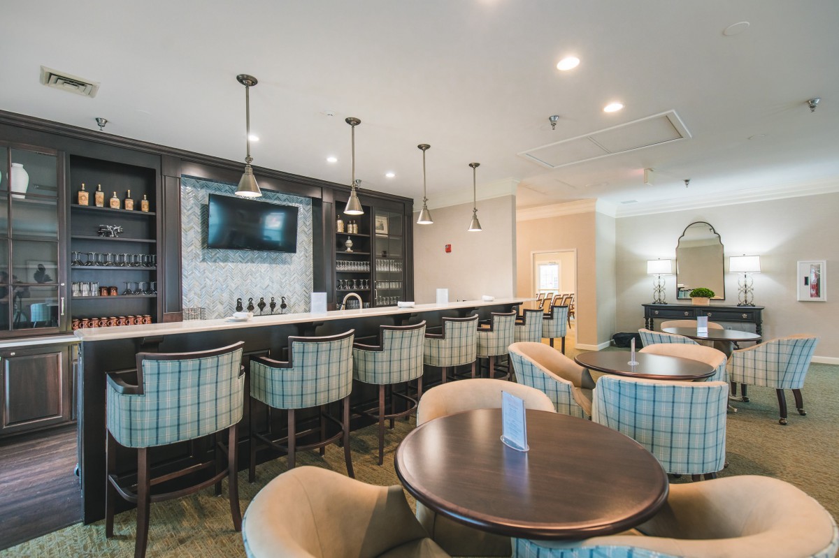 A modern bar area with seating and a television.