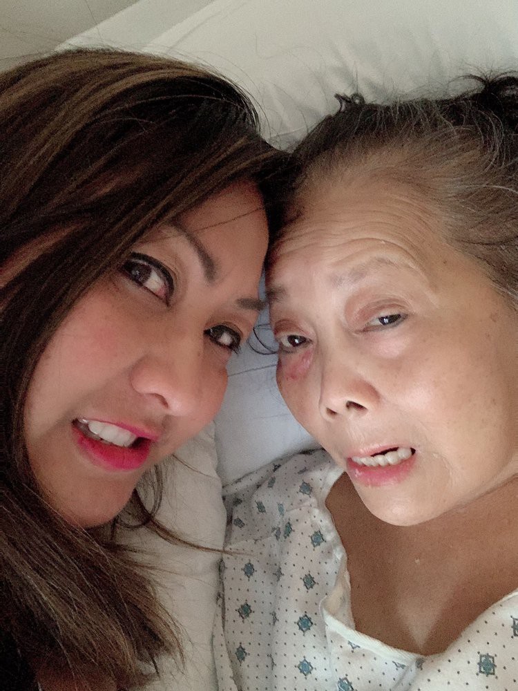 A selfie of two people smiling together.