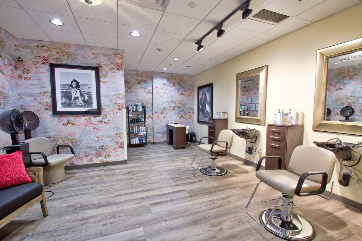 A modern salon interior with stylish decor and seating.
