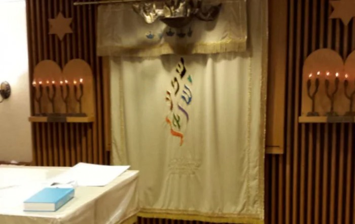 A view of a synagogue ark curtain with Hebrew letters.