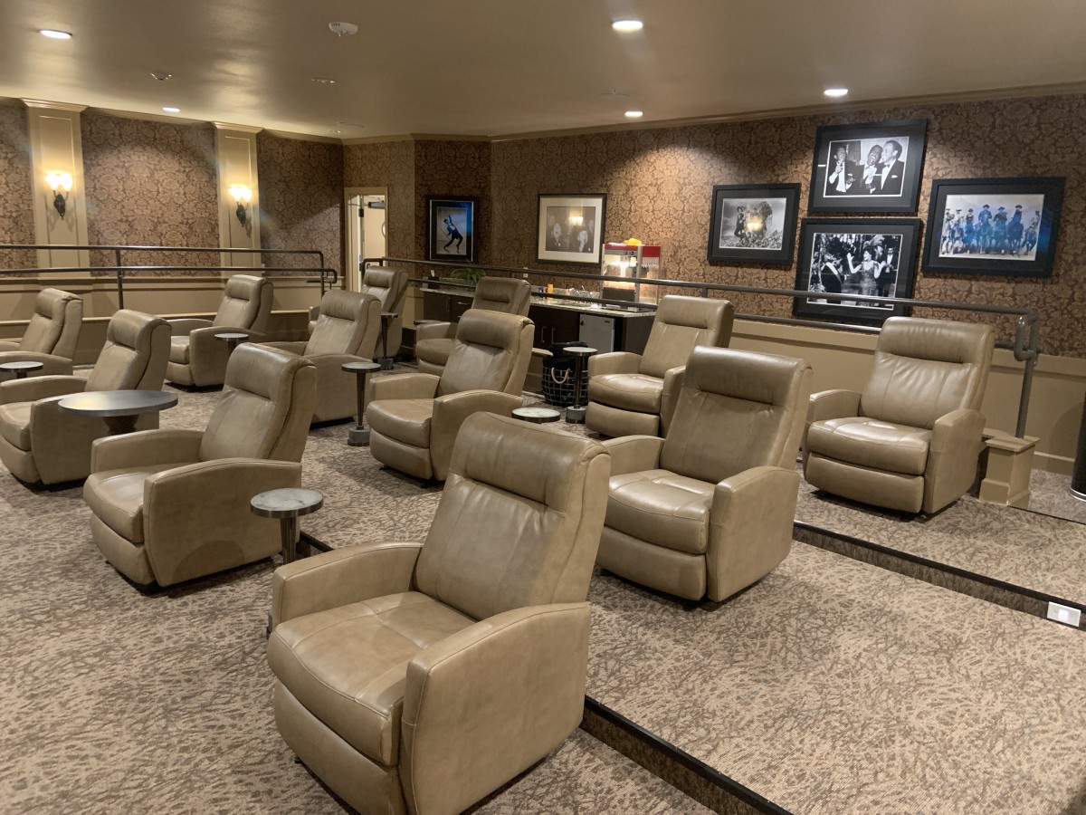 A luxurious home theater with comfortable recliner chairs and elegant interior design.