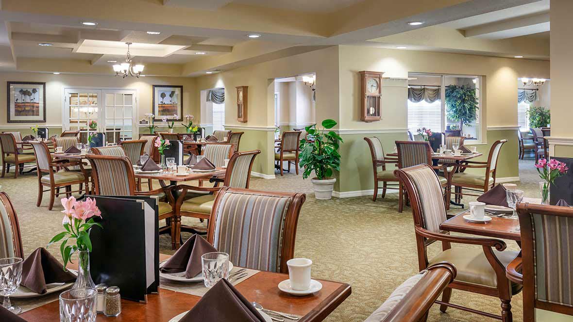 A cozy and elegantly decorated dining room with neatly arranged tables and chairs.
