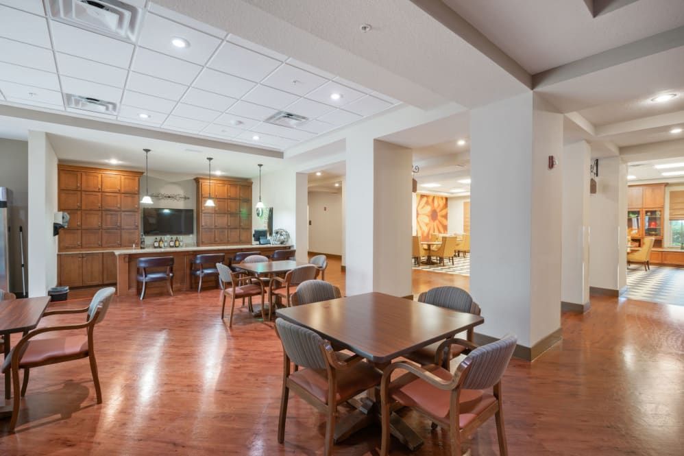 A modern dining area with wooden flooring and open space.