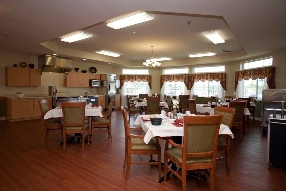 An elegantly arranged dining room with neatly set tables and chairs.