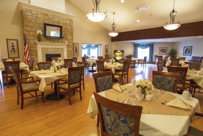 A well-decorated dining area with arranged tables and chairs, featuring a cozy ambiance.