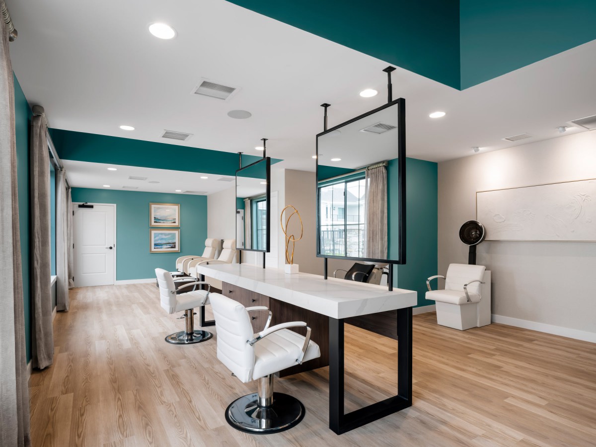 A modern and stylish hair salon interior with sleek design elements, featuring large mirrors, comfortable chairs, and wooden flooring.