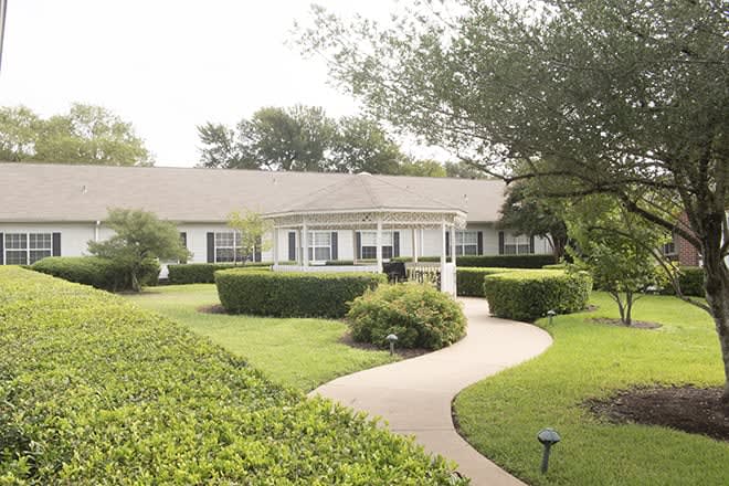 A charming house with a landscaped garden and winding pathway.