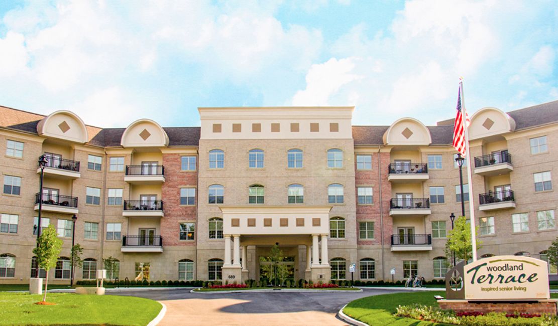 A multi-story residential building with a well-maintained exterior and landscaped front.