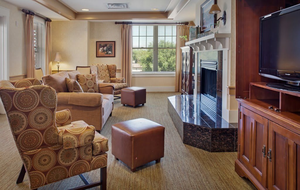 A cozy living room featuring a fireplace, sofas, and elegant decor.