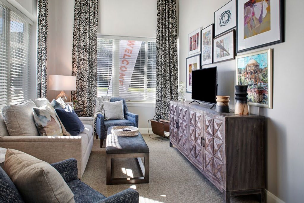 A stylish living room featuring modern furniture and decorative wall art.