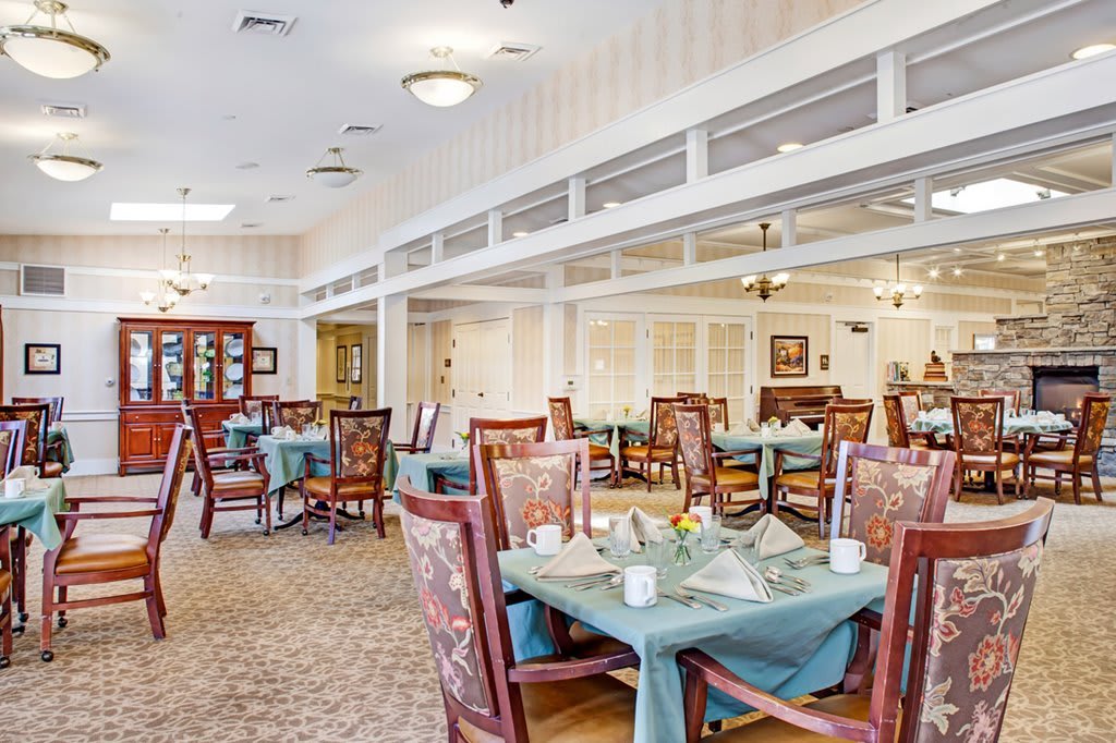 A well-decorated dining area with neatly arranged tables and chairs.