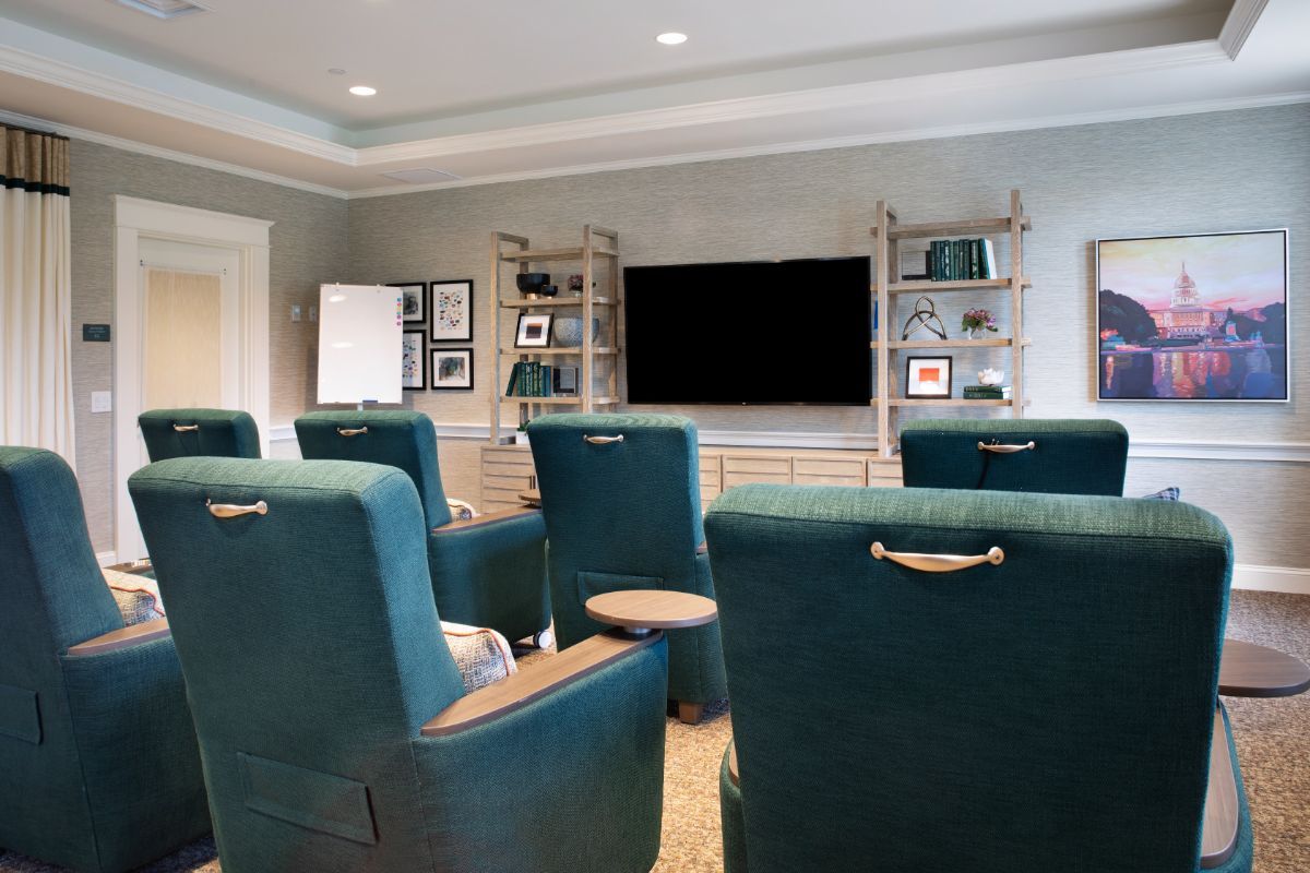 A cozy home theater setup with comfortable seating and a large television.