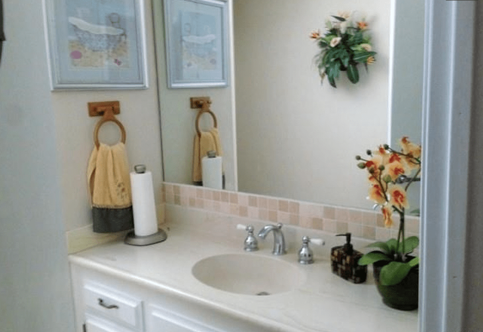 A neatly organized bathroom counter with towels and floral decor.