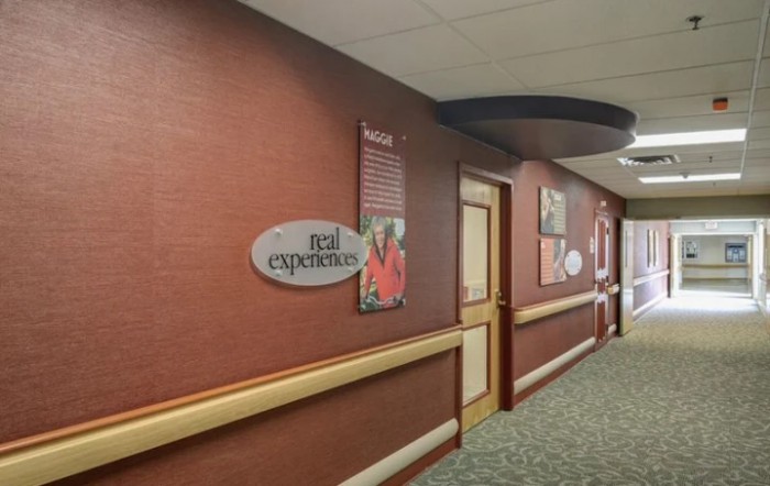 A hallway with artwork and signage on the walls.