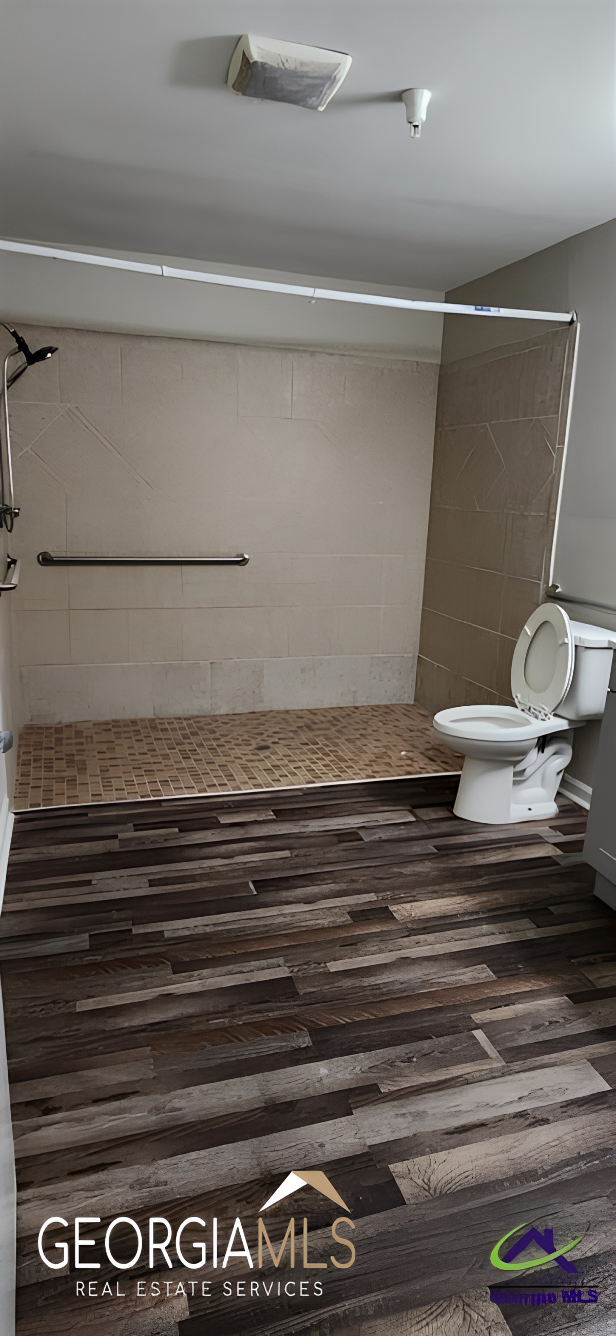 A modern accessible bathroom with a roll-in shower.