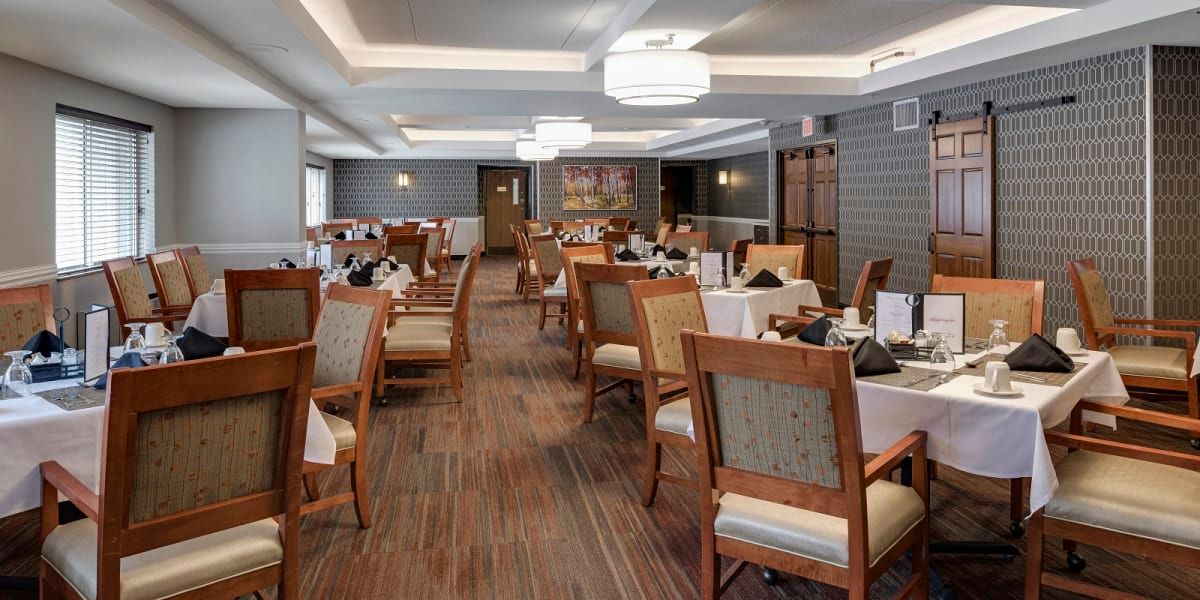 An elegantly designed restaurant dining room with neatly arranged tables and chairs.