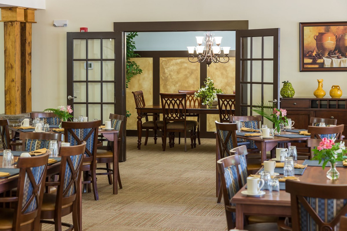 A beautifully arranged dining area with wooden furniture and elegant lighting.