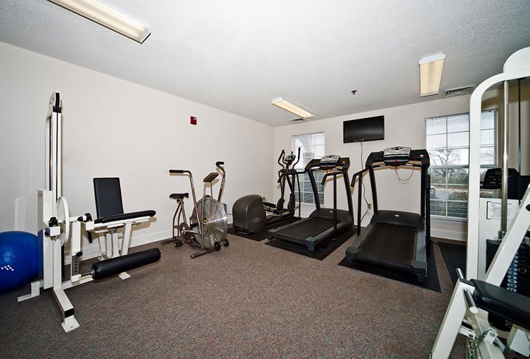 A small gym with treadmills and a stationary bike available for workouts.