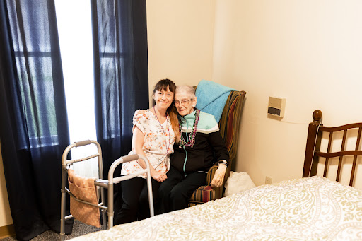 A heartwarming moment shared between a caregiver and an elderly person, highlighting the bond of care and companionship.
