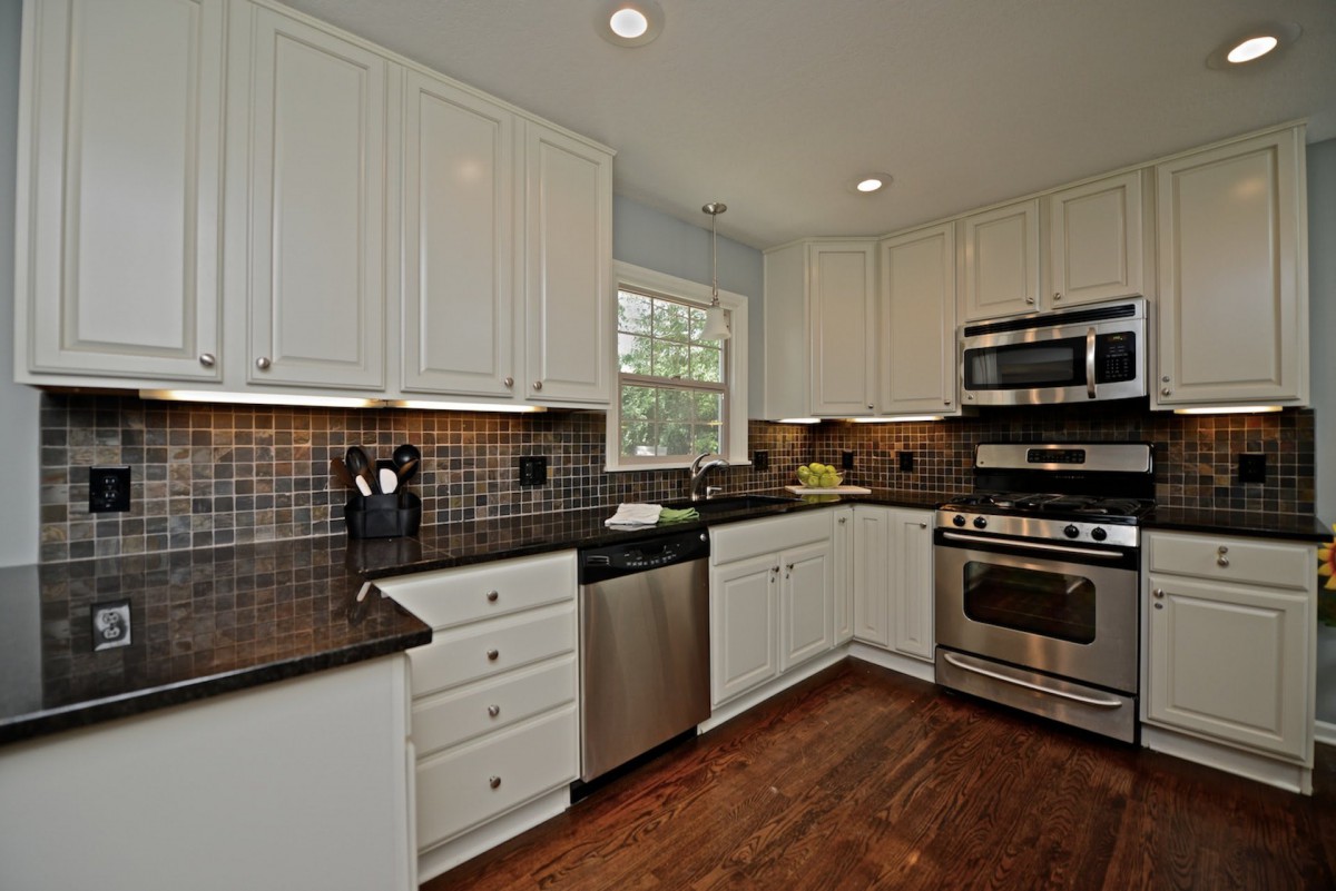 Kitchen and dining area with appliances.