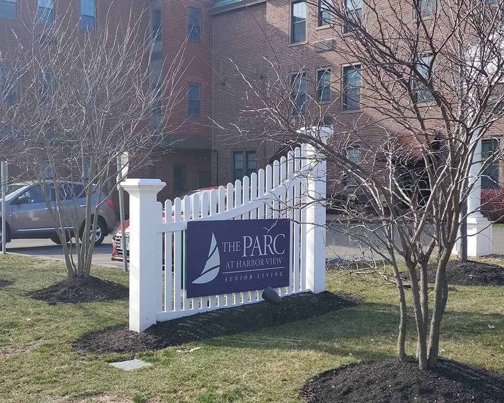 The image shows a sign for a real estate property named 'The Parc on Plymouth'.
