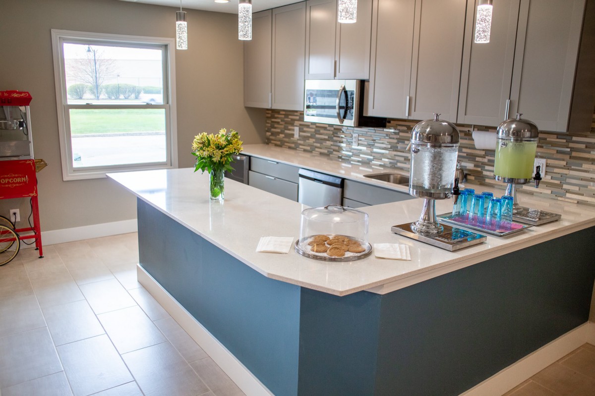 A modern kitchen with a sleek island, contemporary cabinets, and decorative elements.