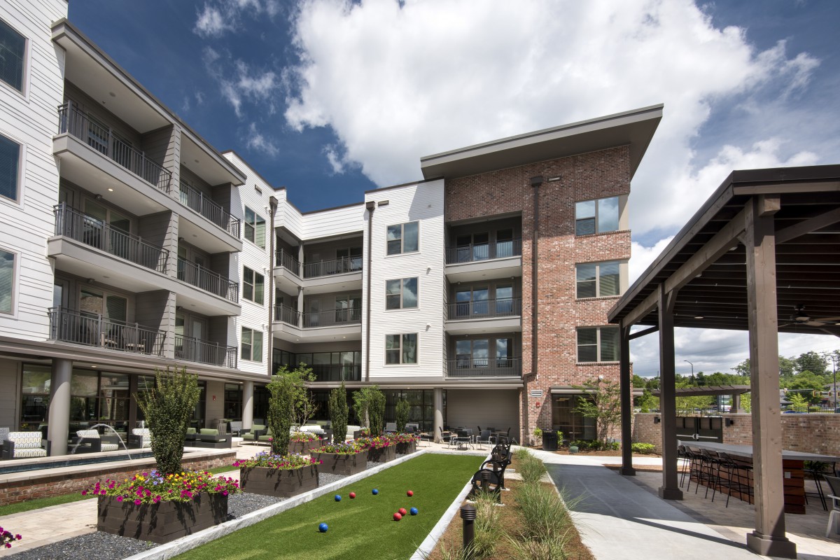 A modern apartment complex with balconies and landscaped outdoor areas.