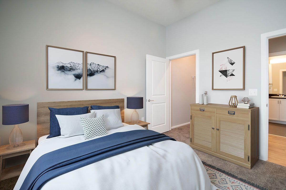 A modern bedroom with a bed, stylish decor, and artwork on the walls.