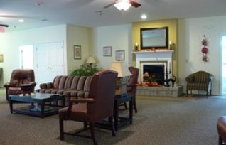 A cozy living room featuring a fireplace, comfortable seating, and elegant decor.