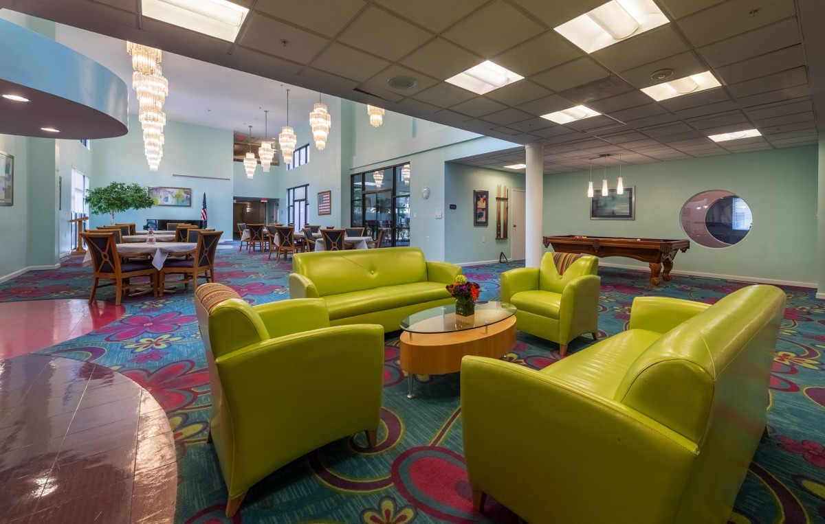A modern lobby featuring bright green furniture and colorful decor.