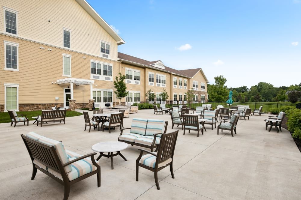 Outdoor patio area with seating in front of a residential building.