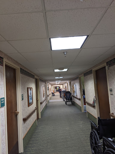 A view down a well-lit corridor with doors lining the walls.