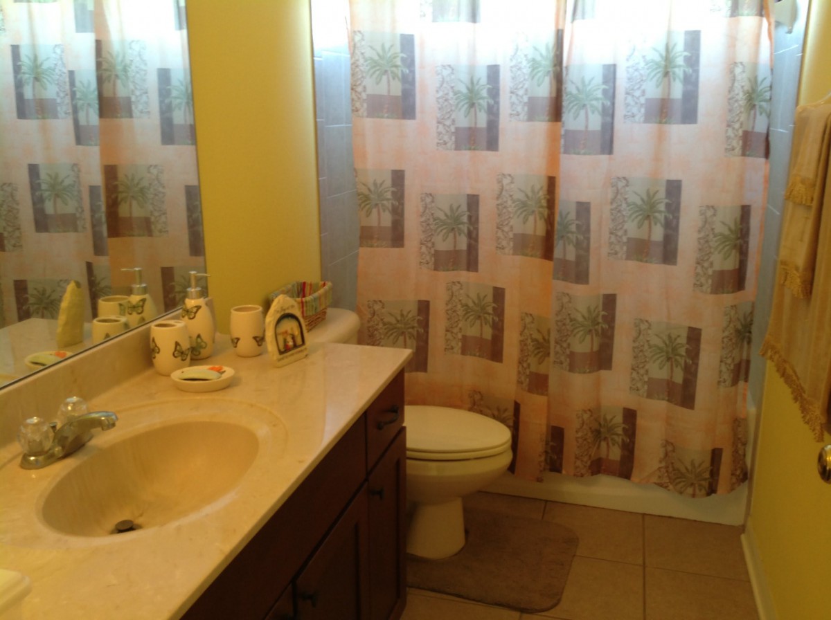 A cozy bathroom with a shower curtain, sink, and toilet.