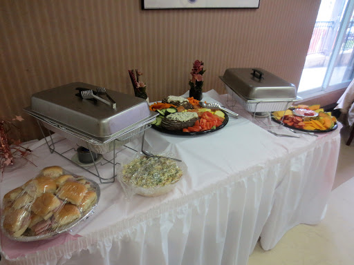 A beautifully arranged buffet table with a variety of dishes including salads, vegetables, and baked goods.