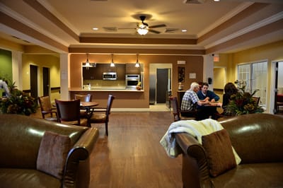 A cozy lounge area with people socializing and comfortable furniture.