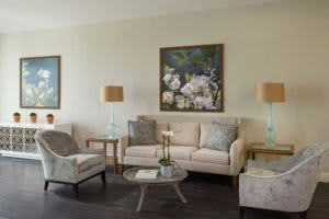 A cozy living room with a sofa, chairs, coffee table, and decorative lamps.
