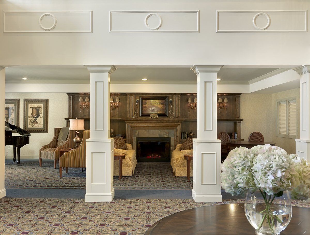 A spacious living room featuring a fireplace, comfortable seating, and elegant decor.