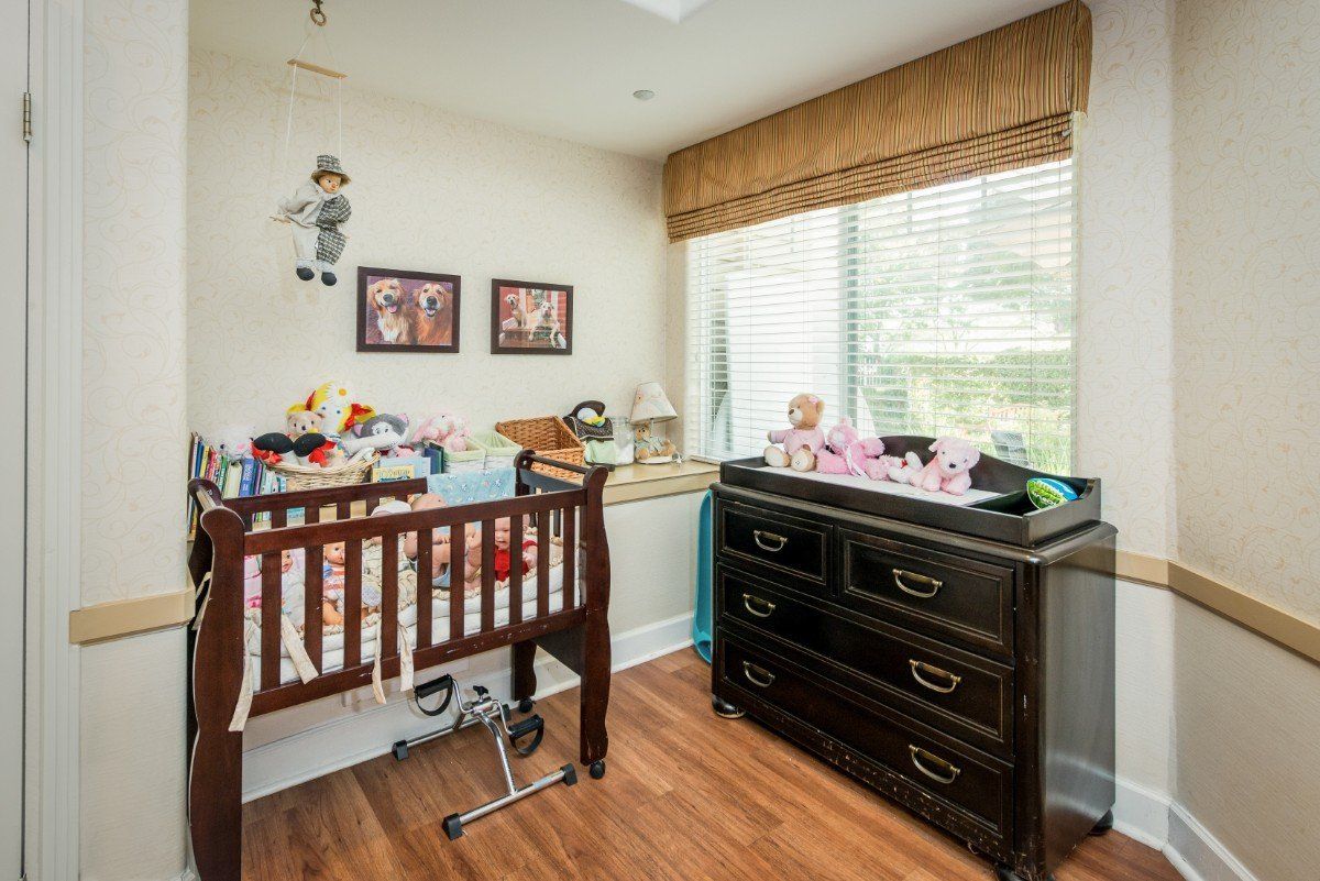 A cozy nursery with a crib, changing table, and toys arranged neatly.