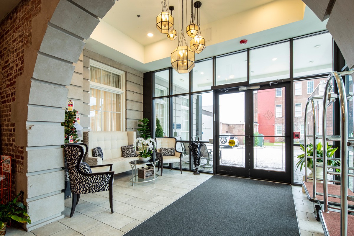 A modern lobby with elegant seating and chandeliers.