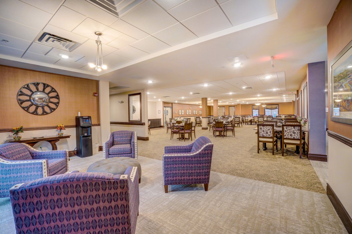 A spacious lounge area with comfortable seating and dining tables.