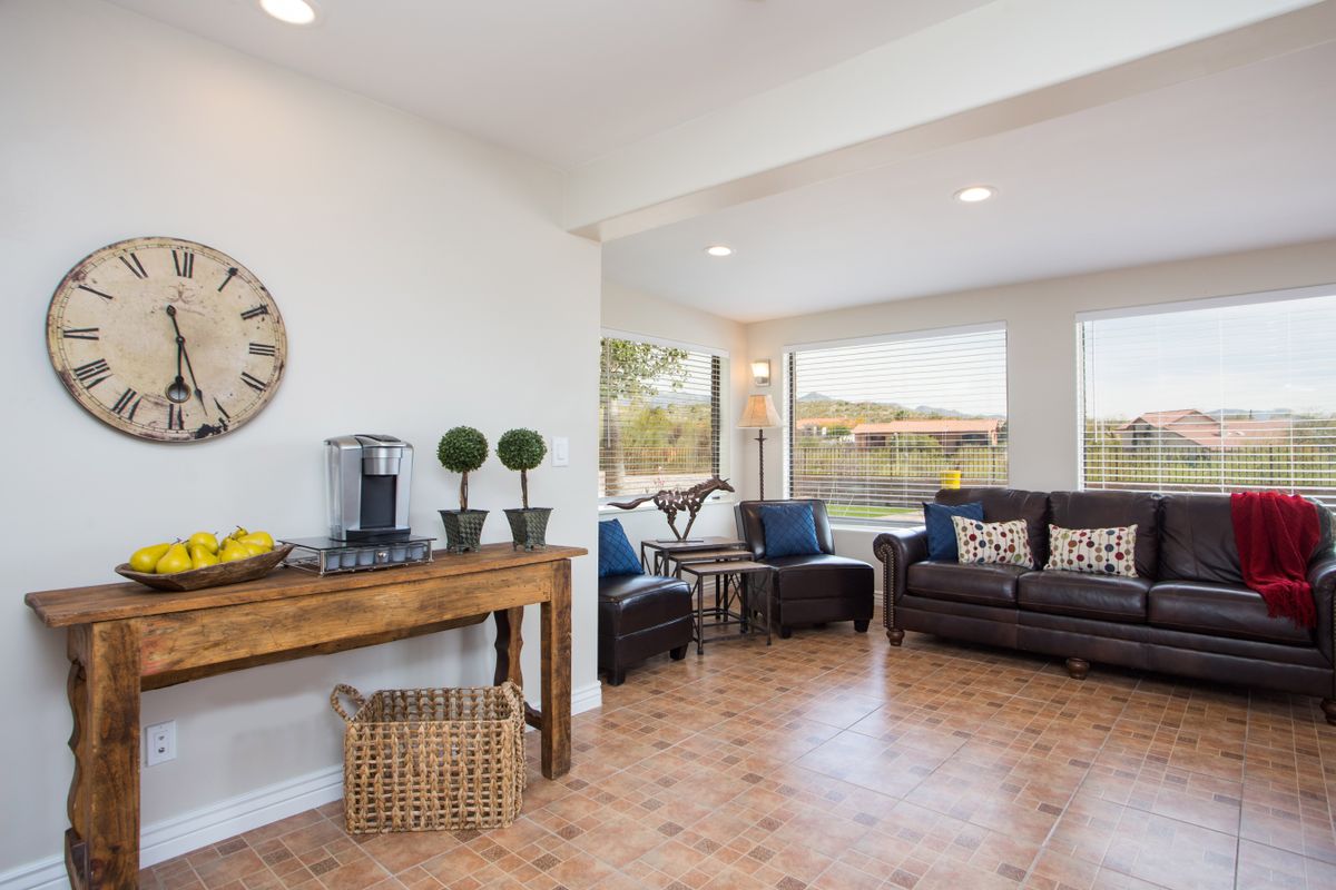 A stylish living room with comfortable seating and large windows.
