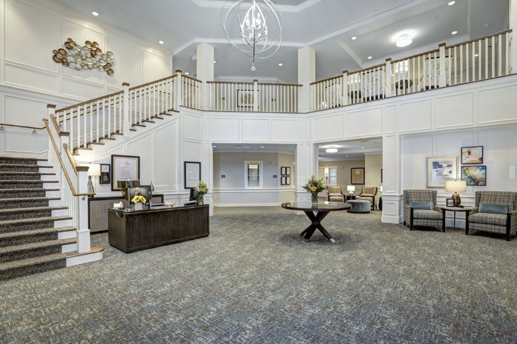 Elegant hotel lobby with a chandelier and modern decor.