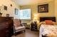 A cozy bedroom with elegant furnishings and warm lighting.