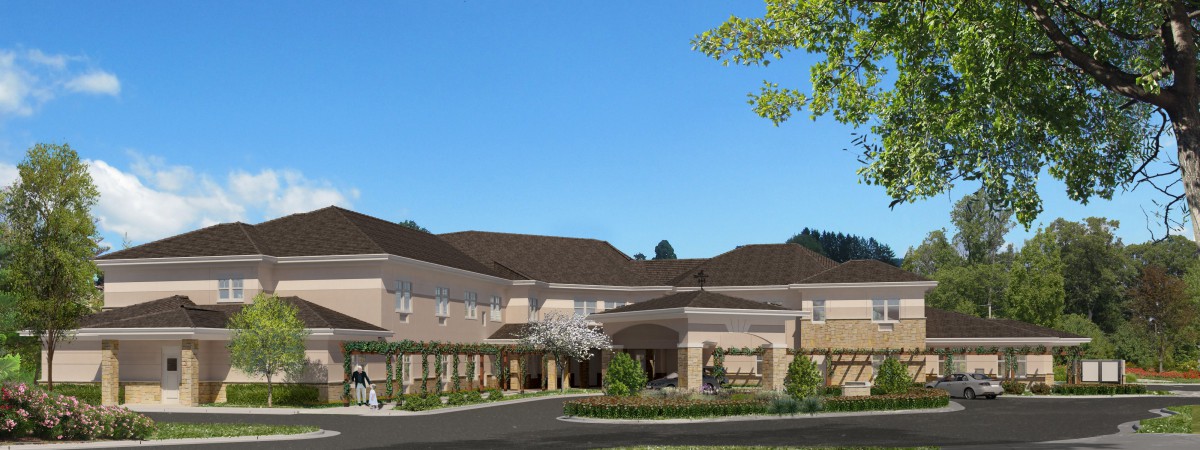 A modern residential building with landscaped surroundings under a clear blue sky.