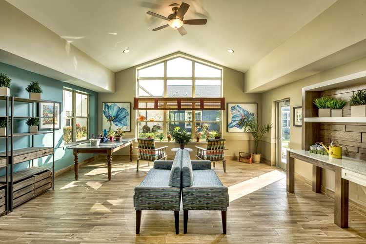 A spacious and modern living room with ample natural light and stylish furnishings.