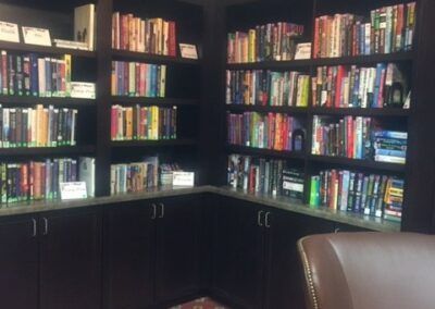 A cozy corner filled with books on dark wooden shelves.