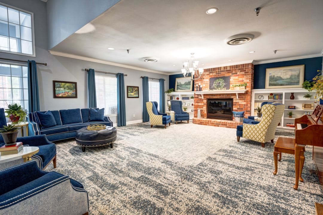 A cozy living room with a fireplace, comfortable seating, and tasteful decor.